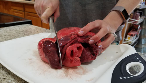 slicing raw caribou heart