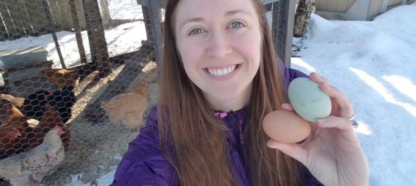 Ashley Taborsky holding a green and brown chicken egg