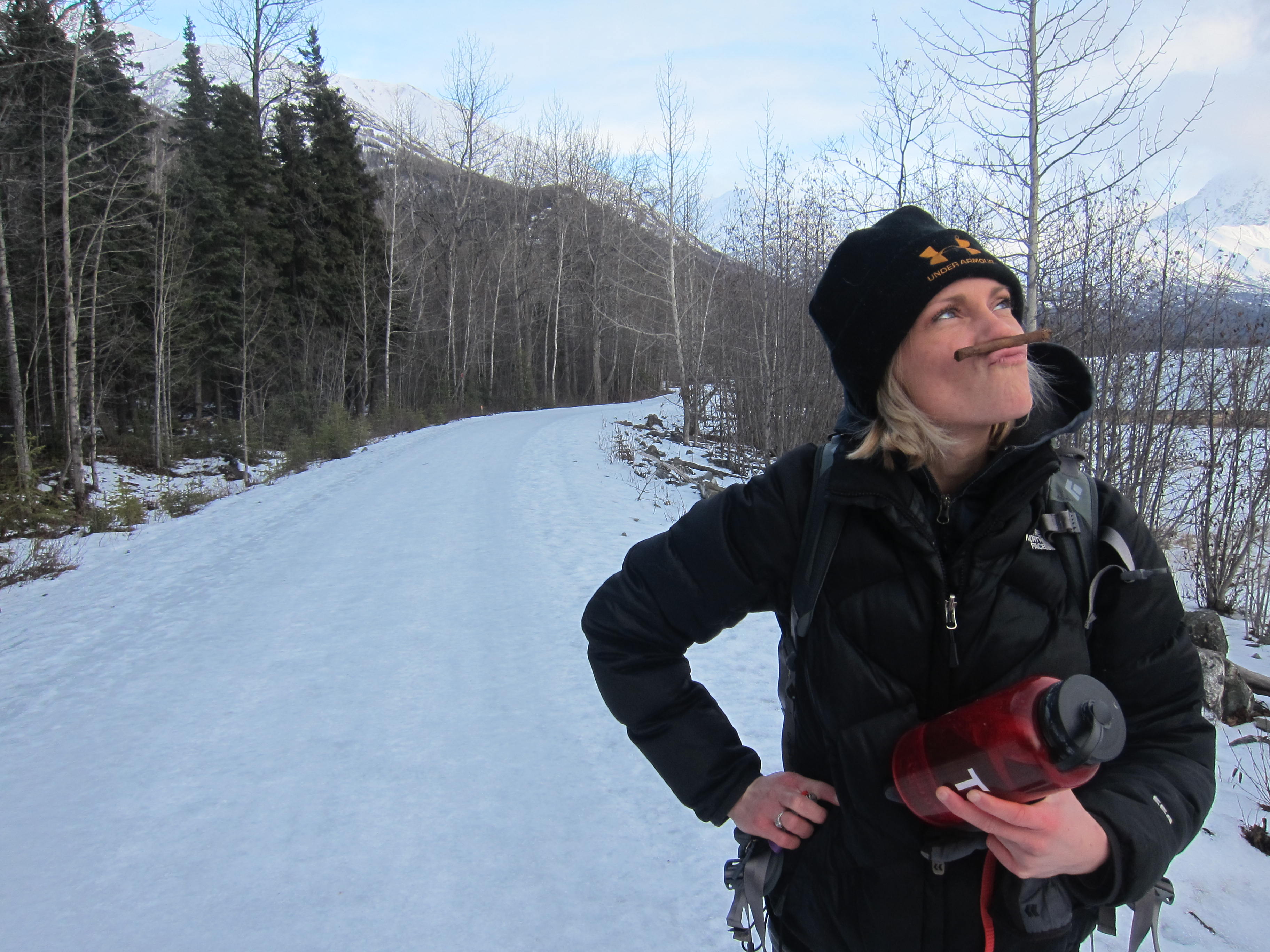 woman with cigar on winter trail