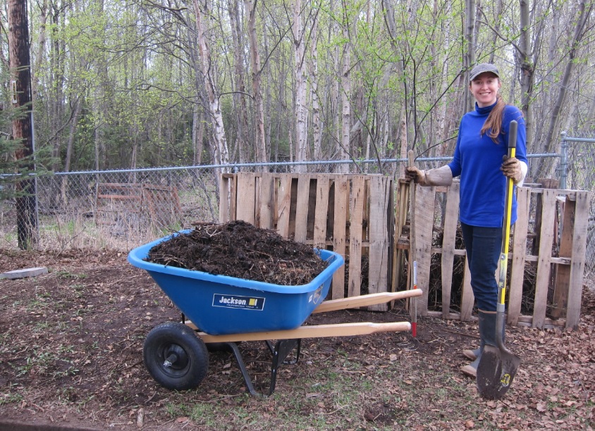 Ashley Taborsky next to compost pile