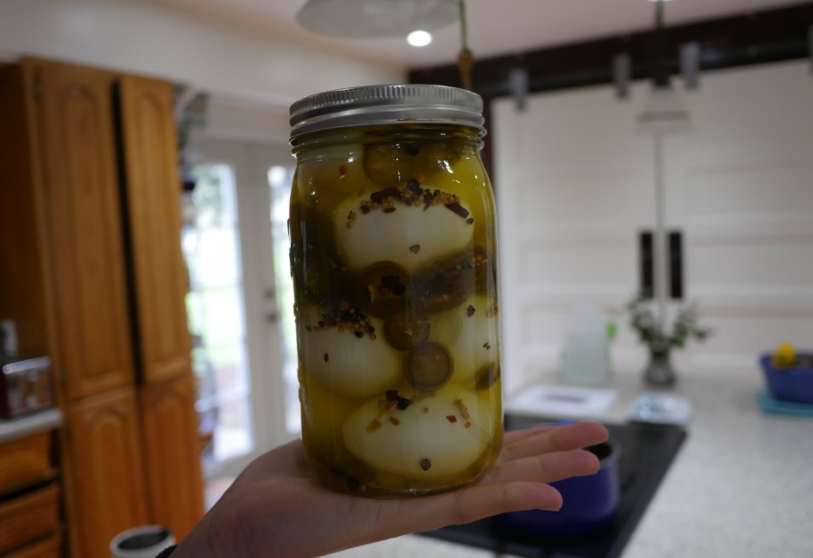 A jar full of spicy jalapeno pickled eggs